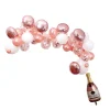 Rosa ballonbue med champagneflaske